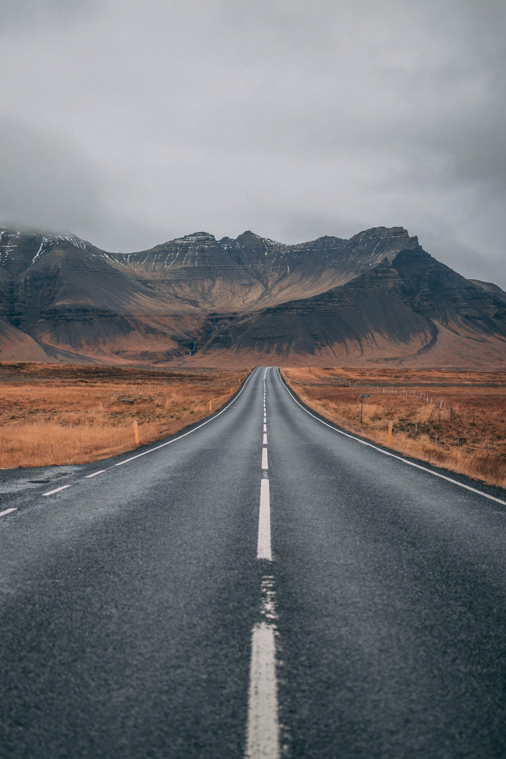 The open road to the mountains sparks idea of adventure